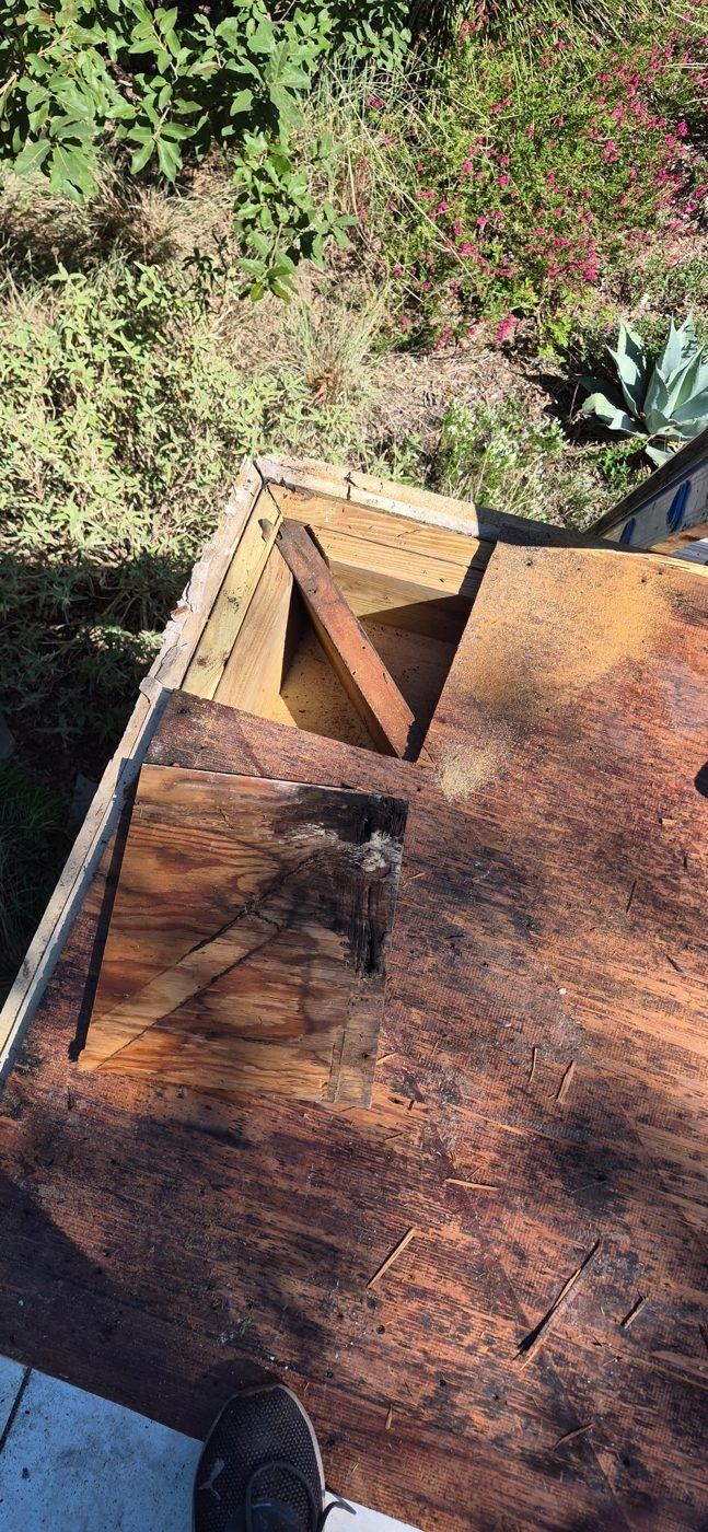 Rotted, cracked roof decking found under the old TPO roof at the corner during tear-out in Wimberley, TX